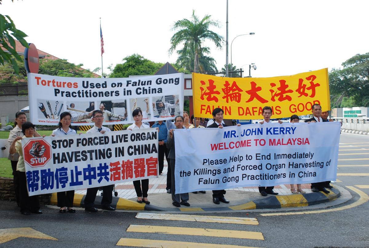 Falun Gong practitioners hold a peaceful assembly near the U.S. embassy in conjunction with the up-coming visit by U.S. Secretary of State John Kerry, in Malaysia, on Oct. 6, 2013. The group urged President Obama to publicly condemn the 14-year-long persecution in China of the spiritual practice Falun Gong. (The Epoch Times)