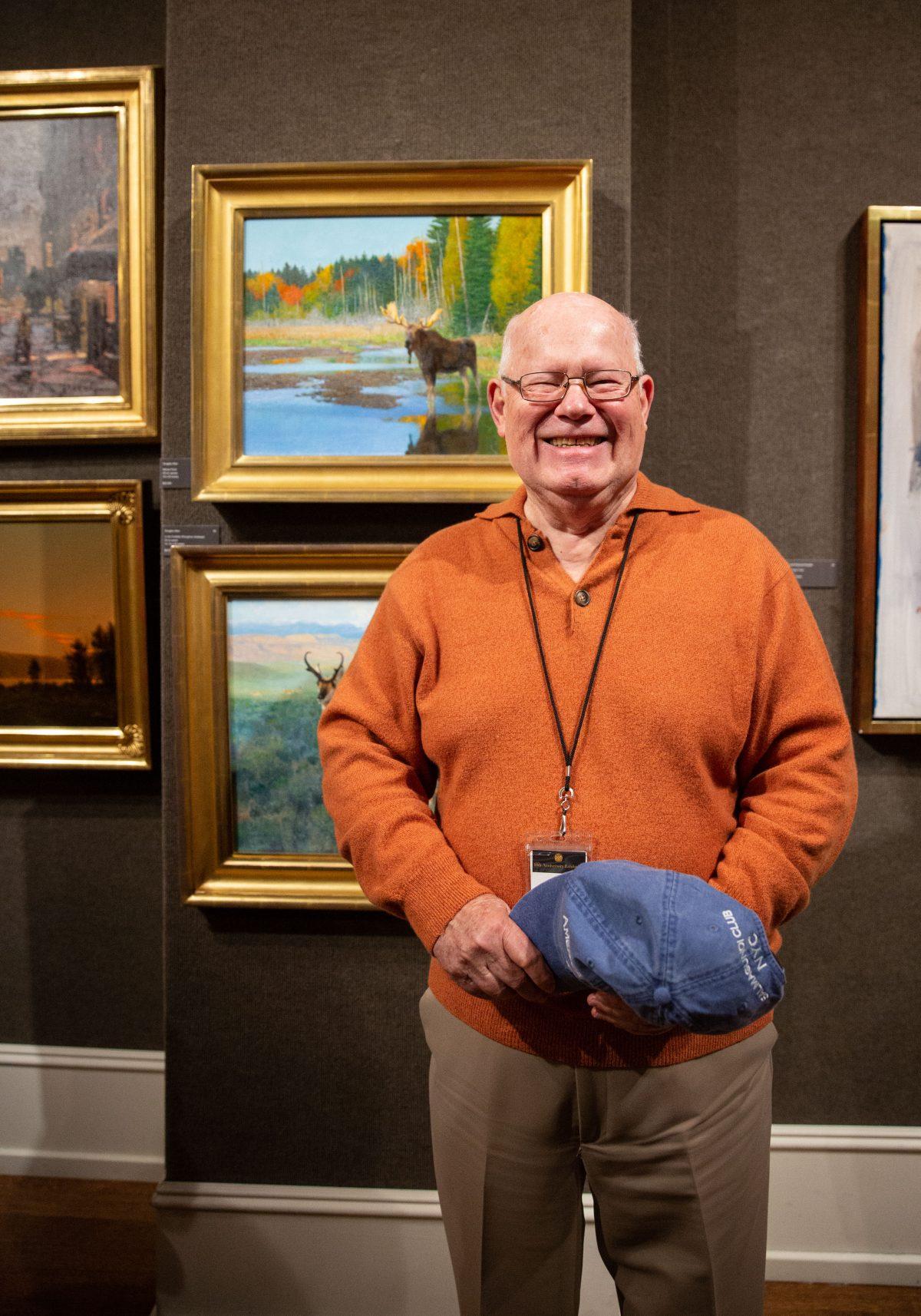 Living Legend artist Douglas Allen by his paintings during the 10th American Masters at the Salmagundi Club on Oct. 13, 2018. (Milene Fernandez/The Epoch Times)