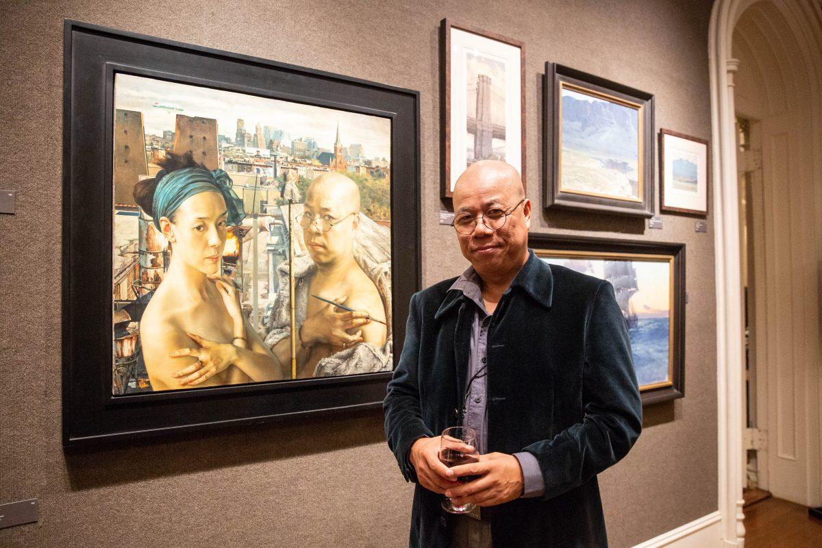 Internationally renowned artist Yuqi Wang with his painting "From Red Hook," 2005. Oil on linen, 30 inches by 30 inches, during the American Masters VIP Reception on Oct. 11, 2018. (Milene Fernandez/The Epoch Times)