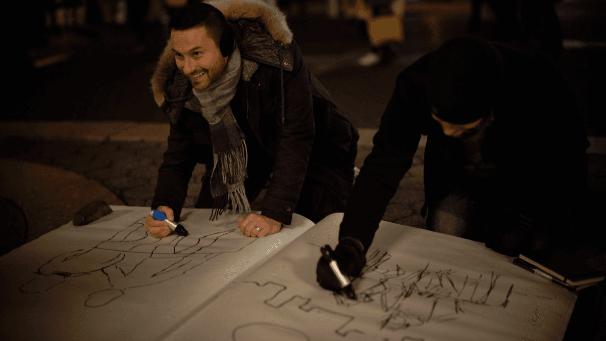 Jarod Neelan (L) and Sean Maze, who built the giant sketchbook, participate in the sketching competition in Union Square, New York, on Jan. 18. (Paul-Emile Cendron/Sugarlift).