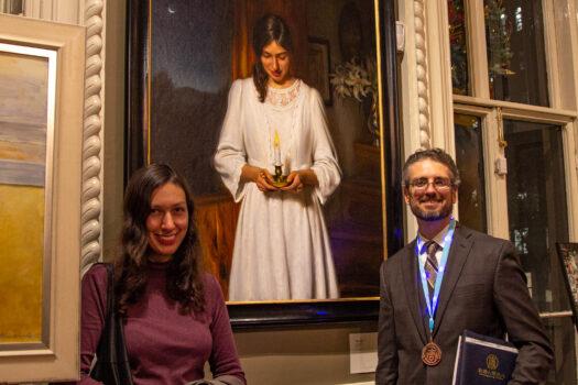 Artist Joseph Daily and his wife Maria in front of his portrait "Maria's Wish" at the 5th NTD International Figure Painting Competition at the Salmagundi Club in New York on Nov. 26, 2019. (Chung I Ho/The Epoch Times)
