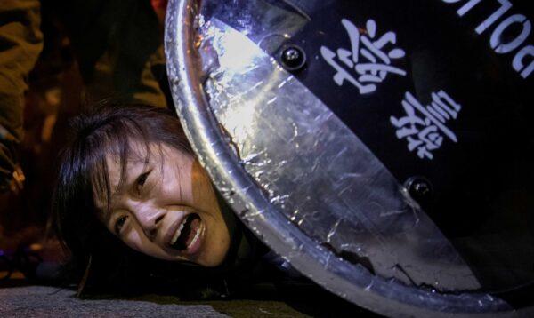 An anti-extradition bill protester is detained by riot police during skirmishes between the police and protesters outside Mong Kok police station, in Hong Kong, on Sept. 2, 2019. (Tyrone Siu/Reuters)