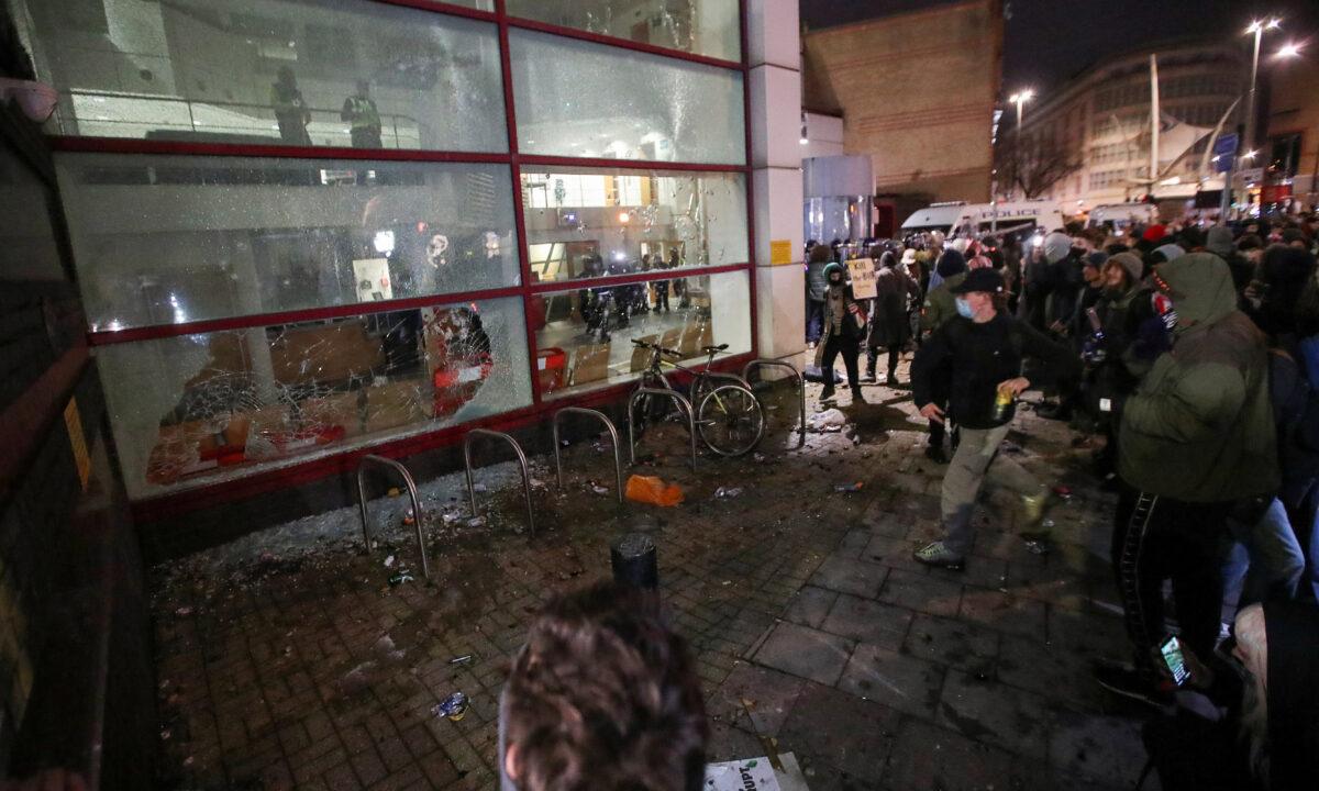 Protesters smash windows of a police station during a protest against a new proposed policing bill, in Bristol, United Kingdom, on March 21, 2021. (Peter Cziborra/Reuters)