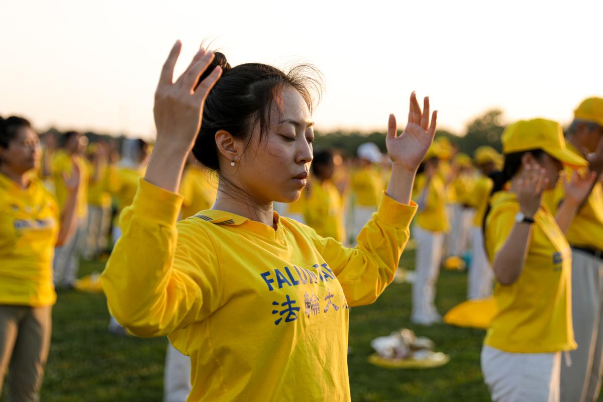 Falun Gong practitioners do exercises at an event marking the 22nd anniversary of the start of the Chinese regime’s persecution of Falun Gong, in Washington on July 16, 2021. (Samira Bouaou/The Epoch Times)