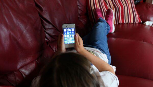 A child uses an Apple smartphone in this undated file image. (PA)
