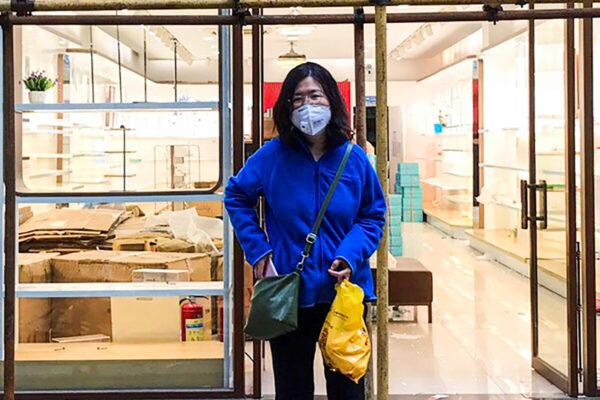 Zhang Zhan stands near scaffoldings outside a shop during a visit to Wuhan, Hubei Province, China, on April 11, 2020. (Courtesy of Melanie Wang via AP)