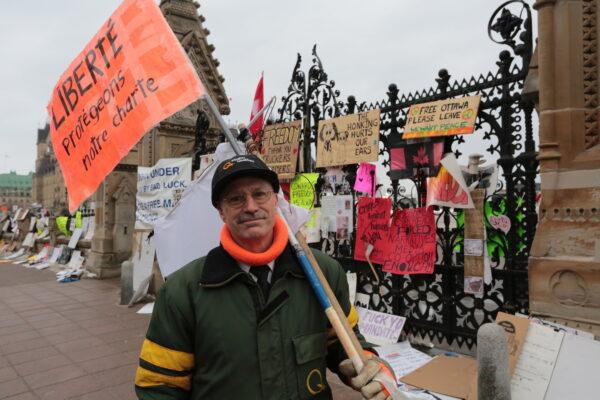 Armand Theriault stand in the Ottawa trucker protest area on Feb. 13, 2022. He came from Quebec to support the truckers and patrols the protest area at night. (Richard Moore/The Epoch Times)