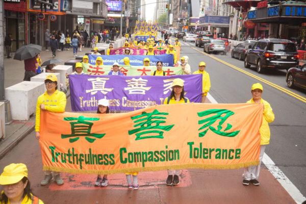 Falun Gong practitioners take part in a parade marking the 30th anniversary of the spiritual discipline's introduction to the public, in New York on May 13, 2022. (Larry Dye/The Epoch Times)