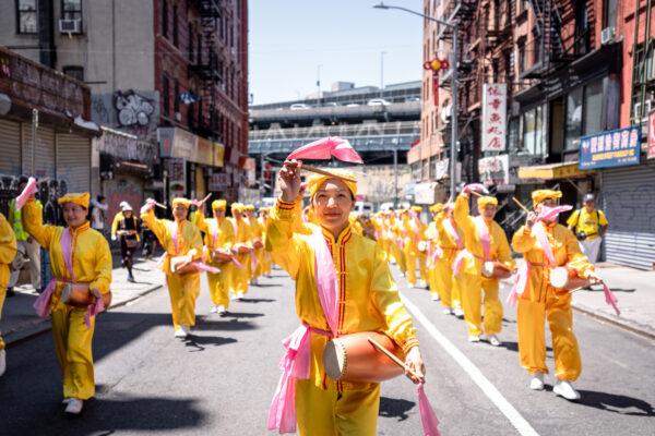 Falun Gong practitioners take part in a parade to commemorate the 23rd anniversary of the persecution of the spiritual discipline in China, in New York's Chinatown on July 10, 2022. (Samira Bouaou/The Epoch Times)