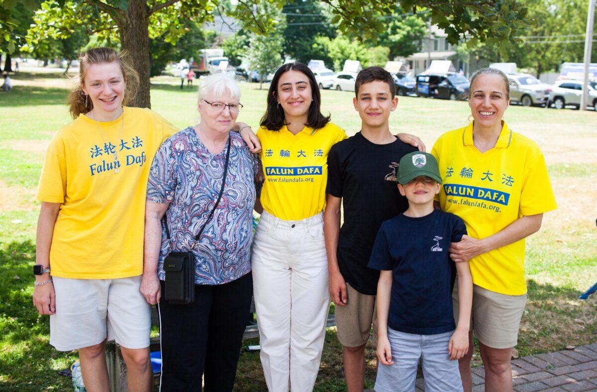 Julia Baniasadi (R) with her daughter Nikou (C) and other family members and relatives at a rally against the persecution of Falun Gong in China, in Goshen, N.Y., on July 17, 2022. (Petr Svab/The Epoch Times)