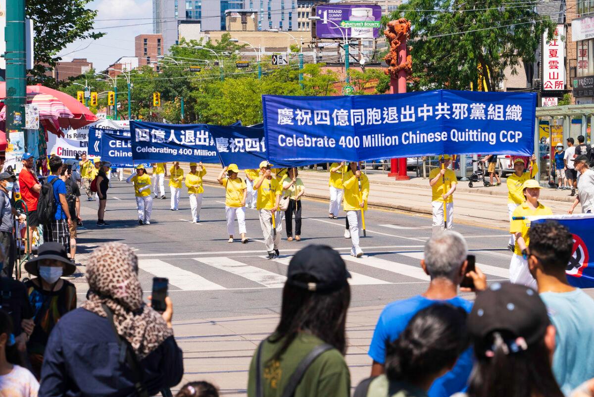 Hundred of people march in a parade in downtown Toronto on Aug. 6, 2022, to celebrate 400 million Chinese people quitting the Chinese Communist Party and its affiliated organizations. (Evan Ning/The Epoch Times)