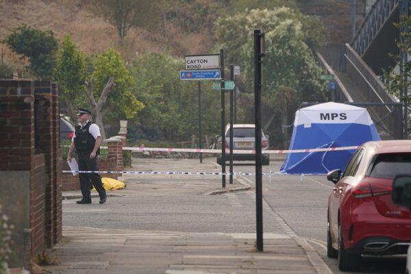 A police tent at the scene where an elderly man who had been riding a mobility scooter was stabbed to death, in Greenford, west London, on Aug. 17, 2022. (PA)