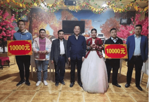 A photo from a report by the Uyghur Human Rights Project showing a village team standing with a newlywed Uyghur-Han couple in Aksu County, a Uyghur-majority prefecture in southern East Turkistan. (Screenshot by The Epoch Times)