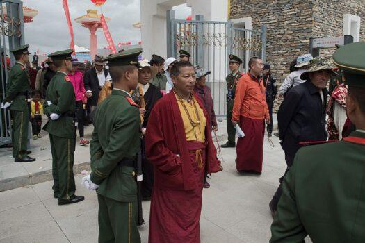 Chinese paramilitary police secure an exit as Tibetan monks leave a stadium at the end of a local government-sponsored festival in Yushu, in the northwestern Chinese province of Qinghai, on July 25, 2016. (Nicolas Asfouri/AFP via Getty Images)