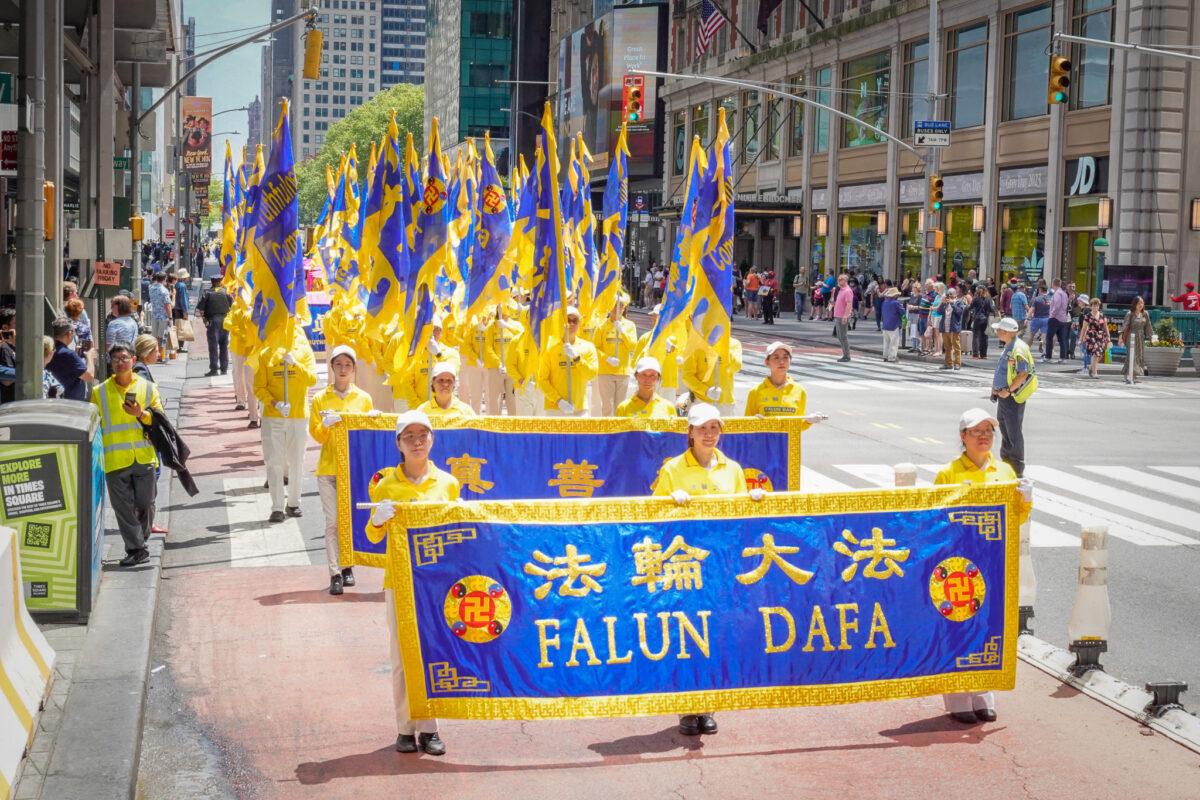 Falun Gong practitioners march in Manhattan to celebrate World Falun Dafa Day on May 12, 2023. (Larry Dye/The Epoch Times)
