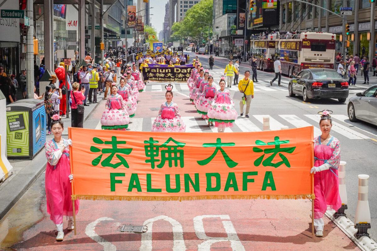 Falun Gong practitioners march in Manhattan to celebrate World Falun Dafa Day on May 12, 2023. (Larry Dye/The Epoch Times)