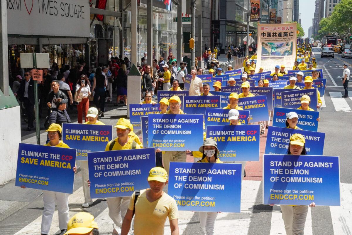 Falun Gong practitioners march in Manhattan to celebrate World Falun Dafa Day on May 12, 2023. (Larry Dye/The Epoch Times)