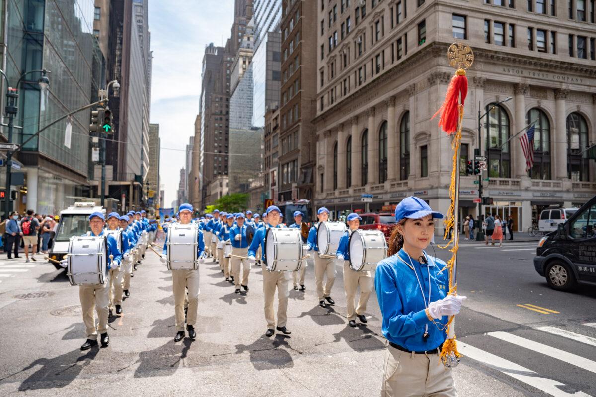 Falun Gong practitioners march in Manhattan to celebrate World Falun Dafa Day on May 12, 2023. (Samira Bouaou/The Epoch Times)