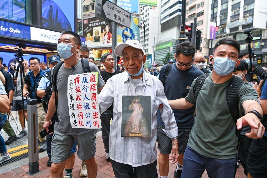 Hong Kong Police on High Security Alert, 87-Year-Old Slogan Bearer Escorted Away on Anniversary of July 1