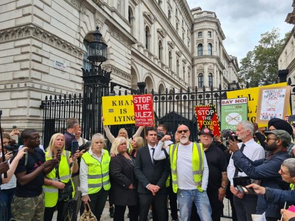 Protesters display signs criticising Mayor of London Sadiq Khan and the ULEZ expansion, outside Downing Street in London, on Aug. 29, 2023. (Joseph Robertson/The Epoch Times)