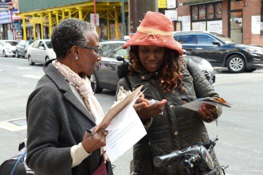 Poet Euraina Jerry (R) was deeply shocked when she heard the truth about forced organ harvesting in Philadelphia Chinatown, on Oct. 15, 2023. (Frank Liang/The Epoch Times)
