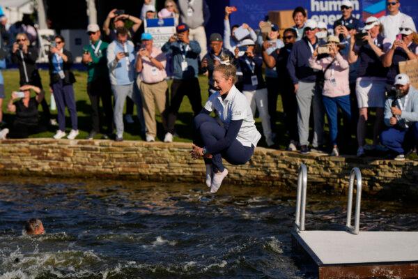 Nelly Korda jumps into the lake after winning the Chevron Championship LPGA golf tournament in The Woodlands, Texas, on April 21, 2024. (David J. Phillip/AP Photo)