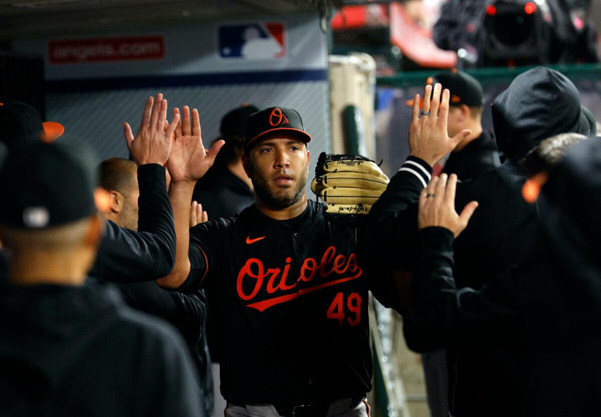 Starting pitcher Albert Suárez #49 of the Baltimore Orioles slaps hands with teammates after coning out of the game in the sixth inning against the Los Angeles Angels at Angel Stadium of Anaheim on April 22, 2024. (Kevork Djansezian/Getty Images)
