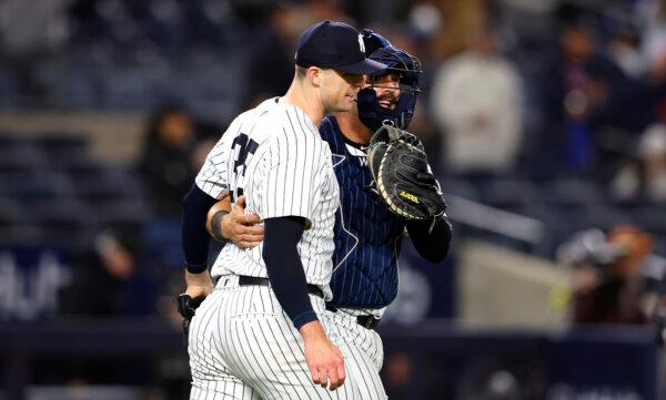 Yankees pitcher Clay Holmes and catcher Austin Wells smile after finishing off a 4-3 win over the A's in New York on April 23, 2024. (Noah K. Murray/AP Photo)