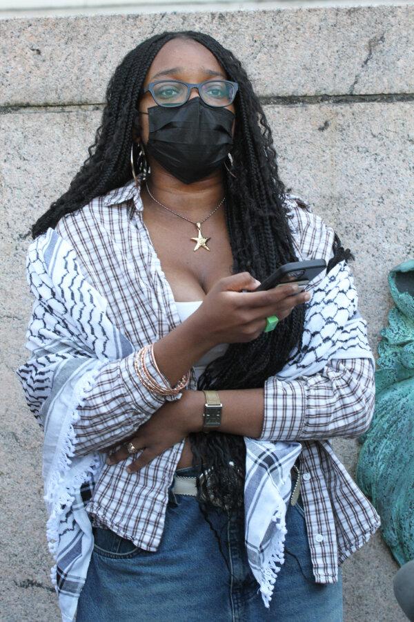 A student protest spokesperson, who wanted to be known only as "W," speaks to reporters at Columbia University in New York City on April 23, 2024. (Richard Moore/The Epoch Times)