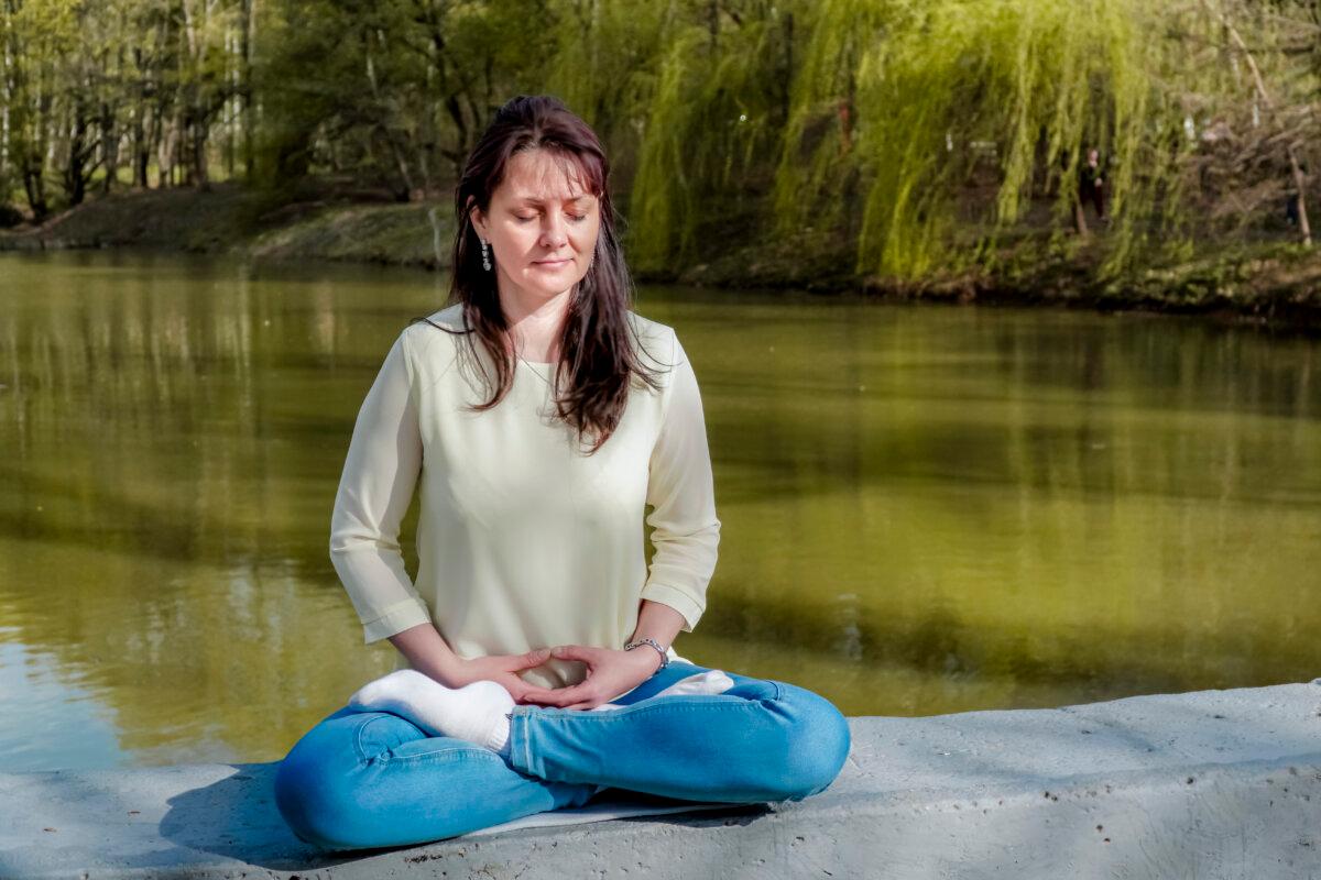 Natalya Minenkova does the Falun Gong meditation in Dendropark in Moscow, Russia, on July 5, 2022.