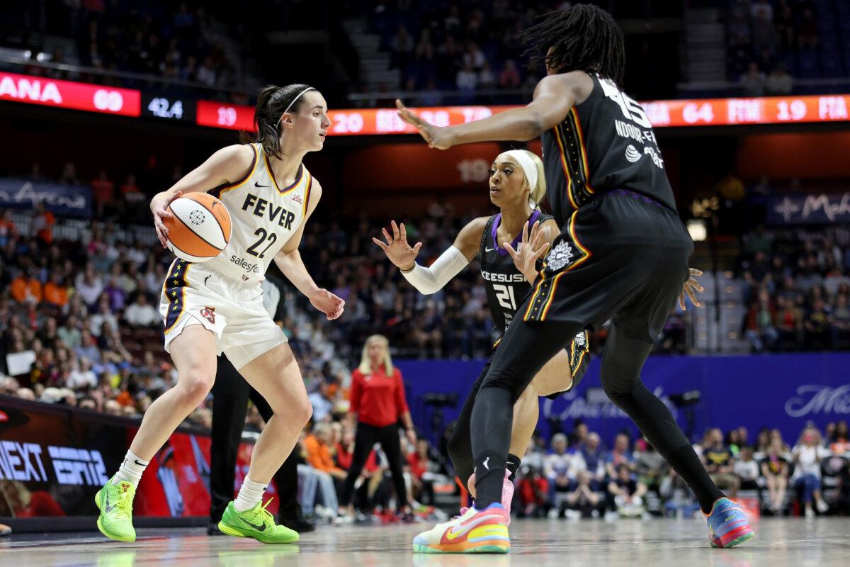 Caitlin Clark #22 of the Indiana Fever dribbles the ball against Astou Ndour-Fall #45 and DiJonai Carrington #21 of the Connecticut Sun in the game at Mohegan Sun Arena in Uncasville, Conn., on May 14, 2024. (Elsa/Getty Images)