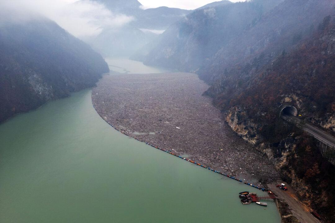 TOPSHOT - An aerial view shows waste and debris floating behind a floating fender on the Drina River, near Visegrad, eastern Bosnia and Herzegovina, on February 6, 2026. The waste and debris were carried into the Drina River from neighboring municipalities in Bosnia and the neighboring countries of Serbia and Montenegro, after the recent snow-melt and heavy rains. (Photo by ELVIS BARUKCIC / AFP via Getty Images)