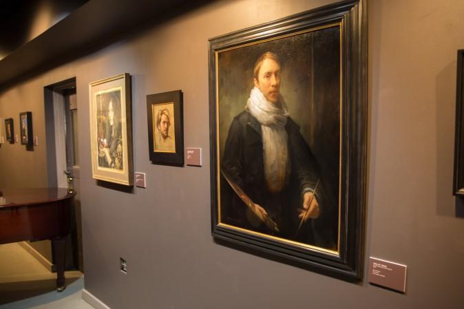 (L–R) Self-portraits by Kamille Corry, Jordan Sokol, and Will St. John displayed at the "Self Portrait" exhibition at Eleventh Street Arts in Long Island City, N.Y., on April 20, 2017. (Benjamin Chasteen/Epoch Times)